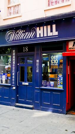 London, United Kingdom - July 22, 2013: Betting Shop at Chinatown, signs are in English and Chinese. Soho District.のeditorial素材