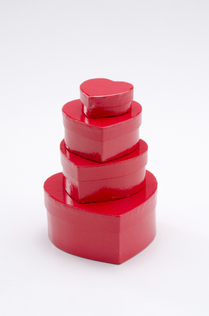 Valentine's Day. Stack of  heart shaped red boxes on white background.の写真素材