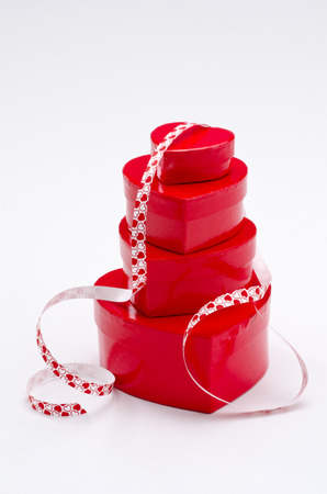 Valentine's Day. Stack of  heart shaped red boxes on white background.の写真素材