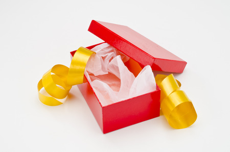 Christmas Present. Open red gift box  with golden ribbon on white background.