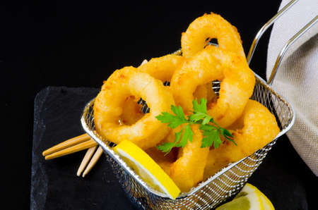 Spanish Tapas. Fried Squid Rings in a basket. Calamares a la Romana.の写真素材