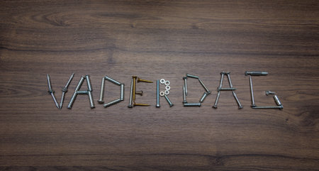 Dutch text Father's Day made of screws on a dark wooden background, Father's Day conceptの写真素材