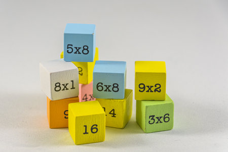 A pair of colorful wooden multiplication table blocks on a white background. Education fin for...