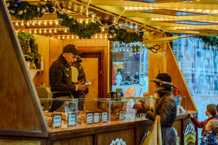 A woman buys oliebollen at an old Dutch pastry stall for New Year's Eveのeditorial素材