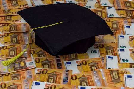 graduation cap on fifty euro banknotes backgroundの写真素材