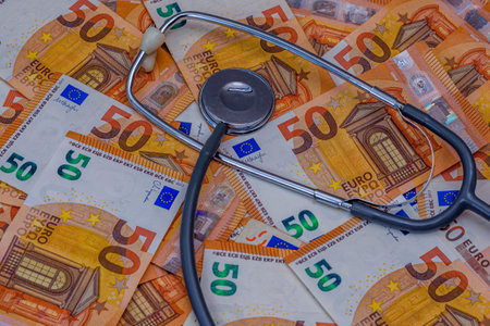 Stethoscope on fifty euro banknotes background. Healthcare financial conceptの写真素材