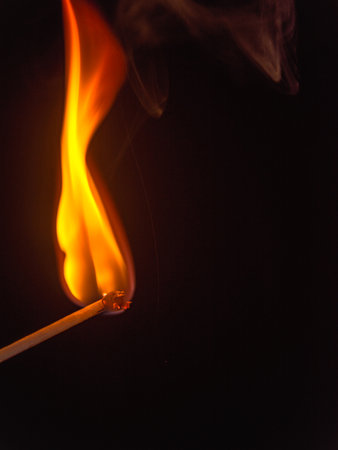 burning match stick on black backgroundの写真素材
