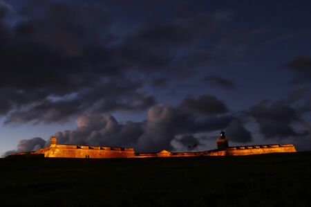 The historical El Morro Fort shrouded in thick clouds at sunset, Puerto Rico.  の写真素材