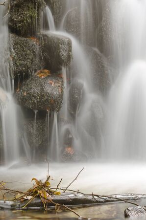 Waterfall and moss covered rocks.の写真素材