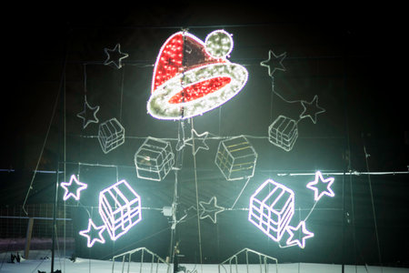 Christmas lights in the shape of Santa Claus on a dark background.の写真素材