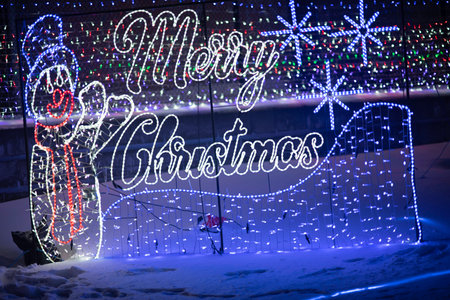 Merry Christmas and Happy New Year greeting card on blurred background.の写真素材