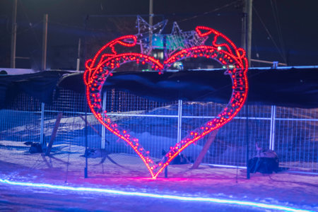 Heart-shaped lights on the background of the night city in the winterの写真素材