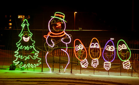 Snowman in the city park at night. Christmas and New Year background.の写真素材