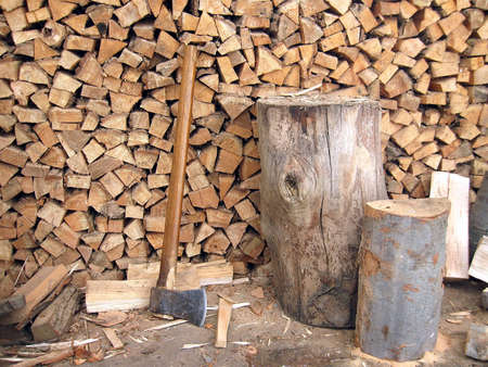 axe blade resting in a piece of firewoodの写真素材