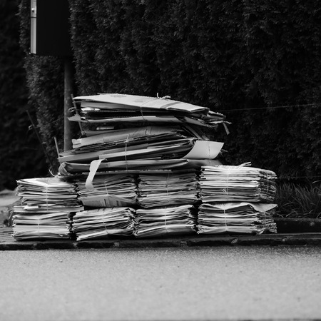 Waste cardboard and paper bundle for recycling. Stack of papers.