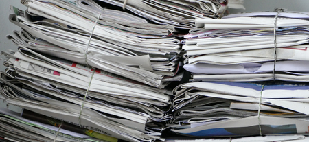 Waste cardboard and paper bundle for recycling. Stack of papers. Close up. Wide horizontal format.の写真素材