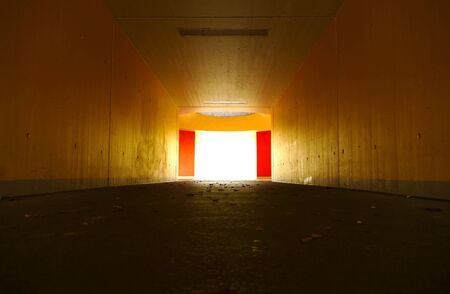 Underpass. A light at the end of the tunnel. A concept image representing hope, faith, endurance, perseverance, freedom, depression, and similar ideas.の写真素材