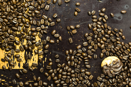 A  cookie  and coffee beans on a scratchy. old wooden surfaceの写真素材