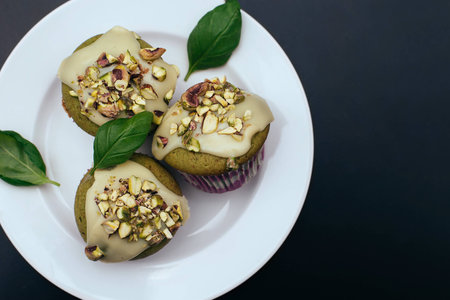 Green basil muffins with white chocolate frostingの写真素材