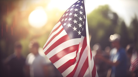 American flag on the background of a crowd of people in the parkの素材