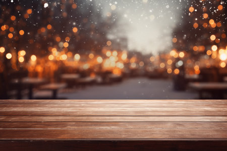 Wooden table against snow falling on city street in winter with bokehの素材