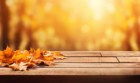 Wooden table with autumn leaves on bokeh background. Autumn backgroundの素材