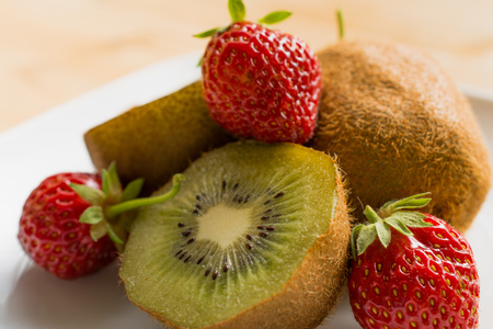 Kiwi with strawberry on plateの写真素材