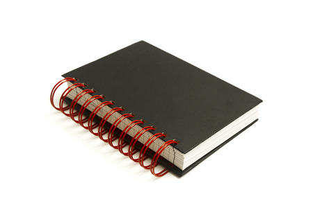 Notebook mockup with black hardcover and red spirals.