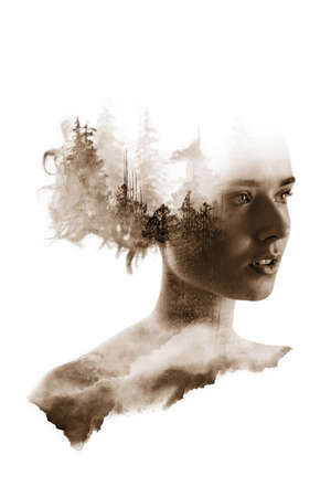 Double exposure portrait of young woman forest and mountains.の写真素材