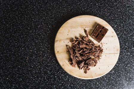 Chopped chocolate on kitchen wooden board.の写真素材