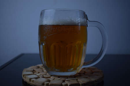 Light beer in a glass on the tableの写真素材