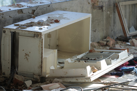 Broken  refrigerator photo from demolition  textile  factory in sunny dayの写真素材