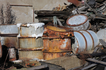 Group of old, rusty barrels with toxic chemical  waste. Photo was taken on place, where textile factory was wrong  demolished.の写真素材