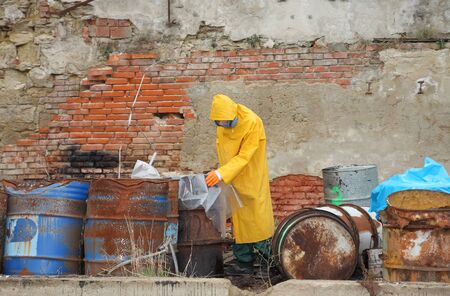 Man with protective  mask and protective  clothes  explores danger area.の写真素材