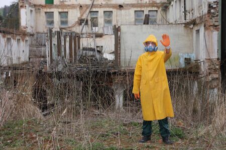 Man with protective  mask and protective  clothes  explores danger area.