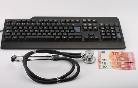 Stethoscope,money, keyboard on white, medical concept.の写真素材