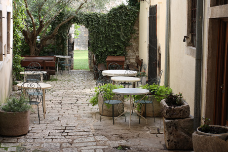 Chairs and tables in front of house.の写真素材