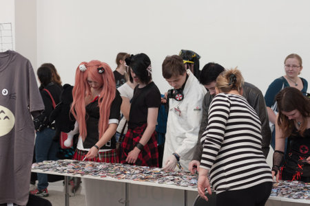 BRNO, CZECH REPUBLIC - APRIL 30, 2016: Visitors of Animefest showing anime buttons at market at Animefest, anime convention on April 30, 2016 Brno, Czech Republicのeditorial素材