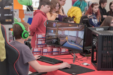 BRNO, CZECH REPUBLIC - APRIL 30, 2016: Young boy sits on gaming chair and plays game on PC at Animefest, anime convention on April 30, 2016 Brno, Czech Republicのeditorial素材