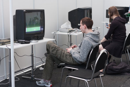 BRNO, CZECH REPUBLIC - APRIL 30, 2016: Teenager plays gaming console with television at Animefest,...
