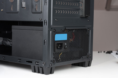 Black computer case; midi tower for ATX motherboard; with inserted power supply.