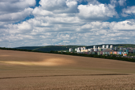 Aerial view of housing estates, residential apartments in the summer day, in foreground a cereal fieldの写真素材