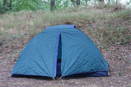 Tourist camping tent in the woods in the summer morning.の写真素材