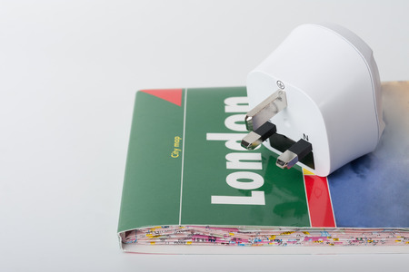 White travel power adapter, European to UK and map of London.の写真素材