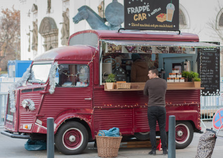 Brno,Czech Republic-November  27,2017: Man is waiting in front of mobile food van  at Christmas market at Moravian Square on November 27, 2017 Brno, Czech Republicのeditorial素材