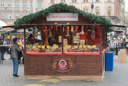 Brno,Czech Republic-December 18,2017: Woman  sales sausage at Christmas market at Liberty Square on December 18, 2017 Brno, Czech Republicのeditorial素材
