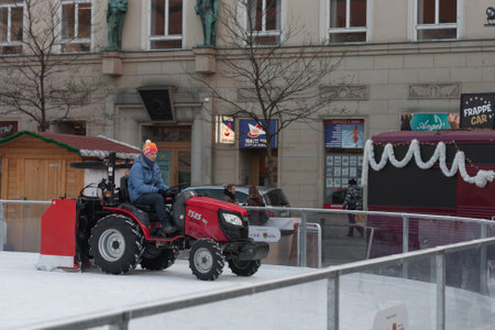 Brno,Czech Republic-December 18,2017: Man in tractor cleans artificial ice rink on Moravian Square on December 18, 2017 Brno, Czech Republicのeditorial素材