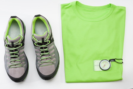 Outdoors shoes, t- shirt and magnetic compass for trail running, free running, fast climbing, hiking, studio shoot on white backgroundの写真素材