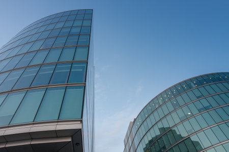 Roof and glass facade of modern skyscraper, blue sky on backgroundのeditorial素材