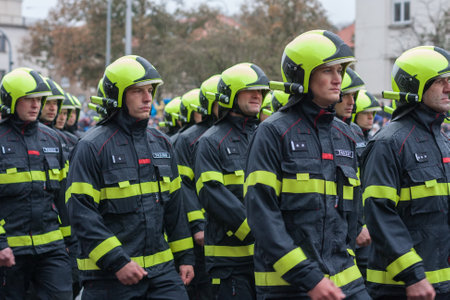 European street, Prague-October 28, 2018: Fire brigade workers  are marching on military parade for...